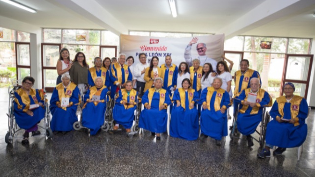 Adultos mayores y escolares se unen para cantar el himno del papa León XI